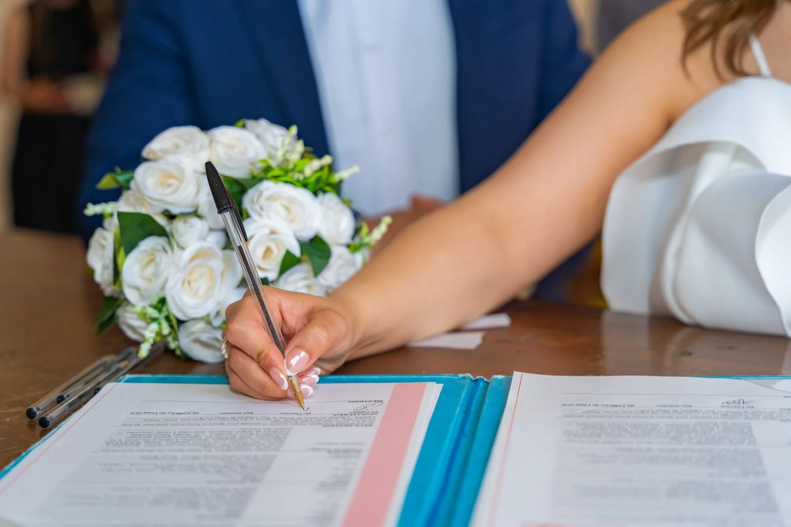 Bride signing the marriage register during a civil wedding ceremony