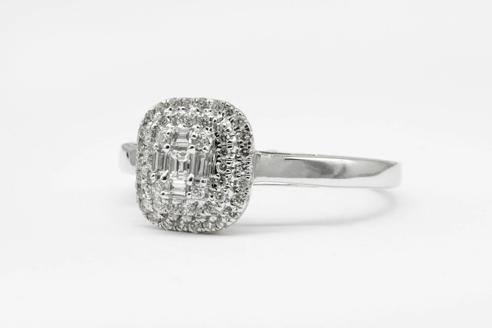 Diamond ring with a baguette-cut centre stone and double halo