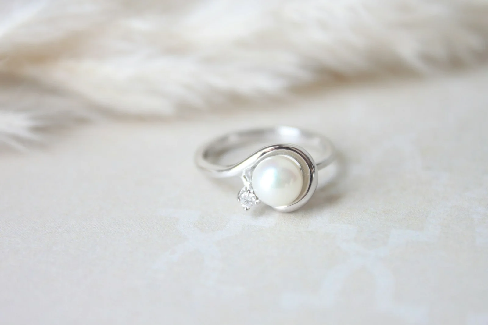 Pearl ring with a small diamond accent
