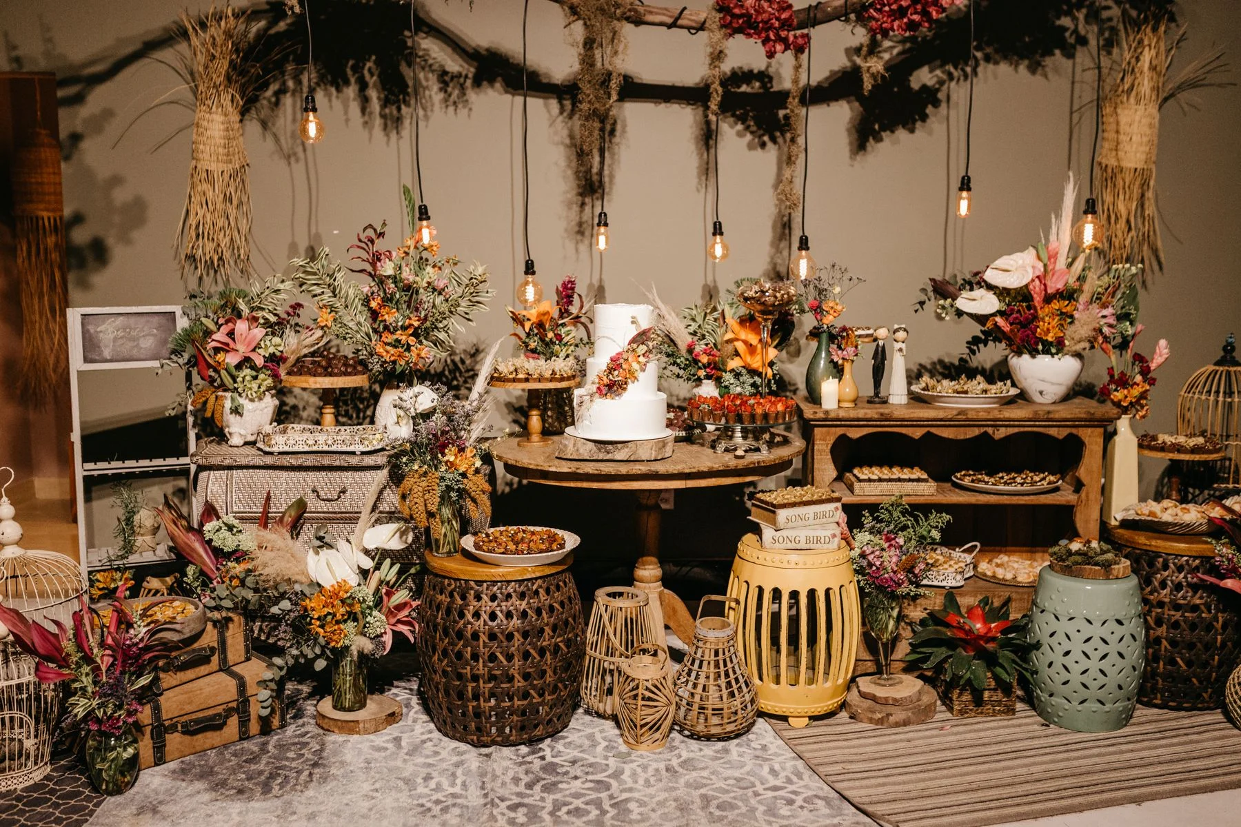 Rustic wedding reception table with flowers and cake