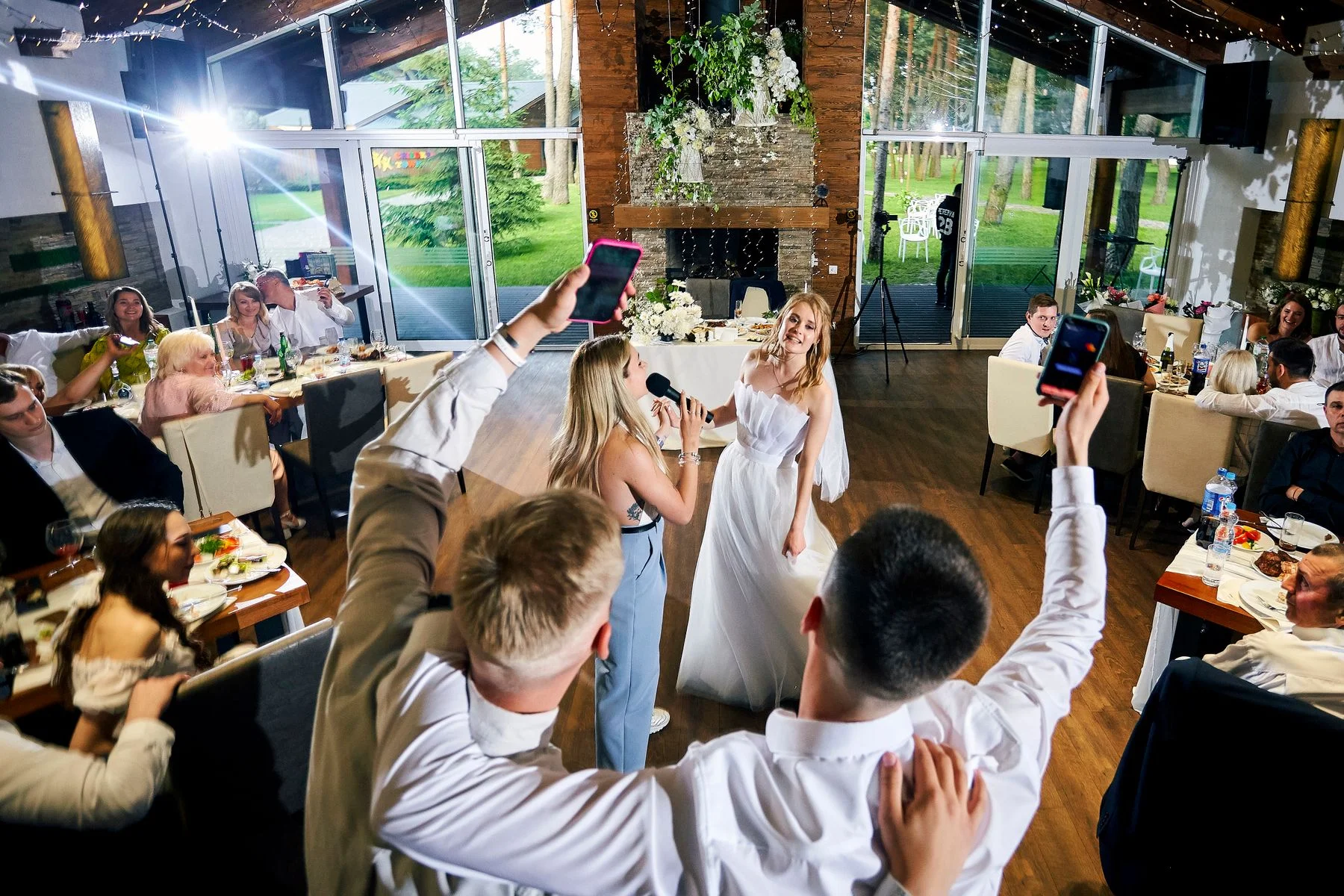 Joyful indoor wedding reception with guests dancing to live music