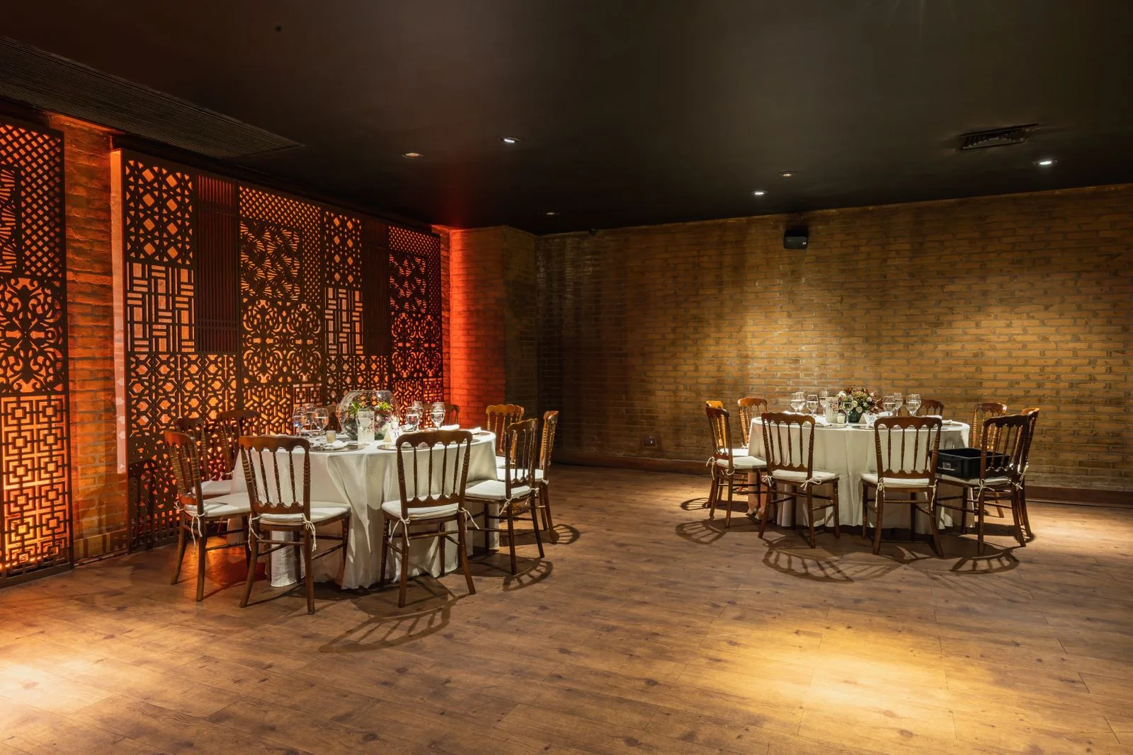 A private dining room with round tables set for a hotel event in New York | Wedded Wonderland