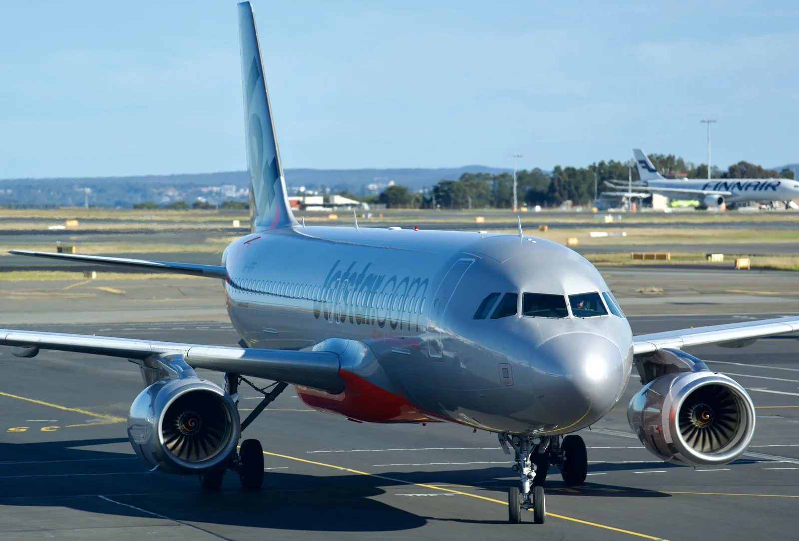 A passenger plane taxiing at Sydney Airport, where the flight to a New York wedding begins | Wedded Wonderland