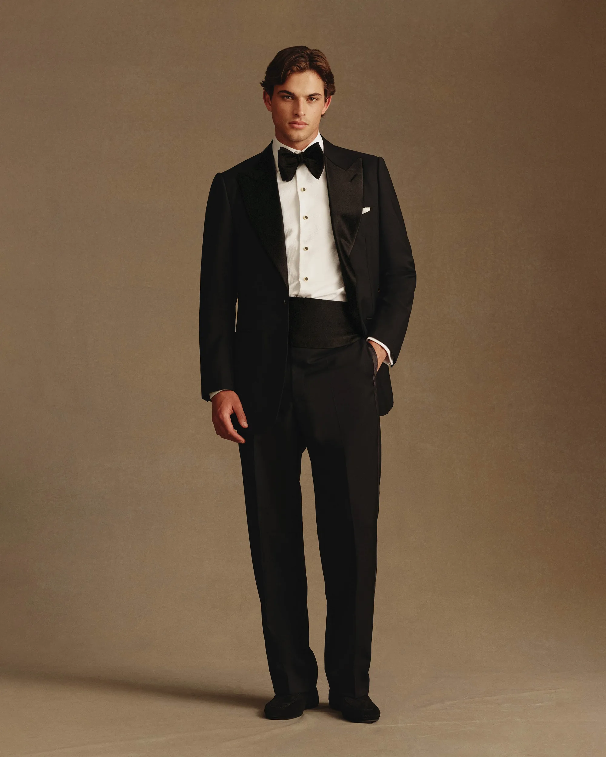 Man in a P Johnson black peak lapel tuxedo with bow tie and cummerbund | Wedded Wonderland