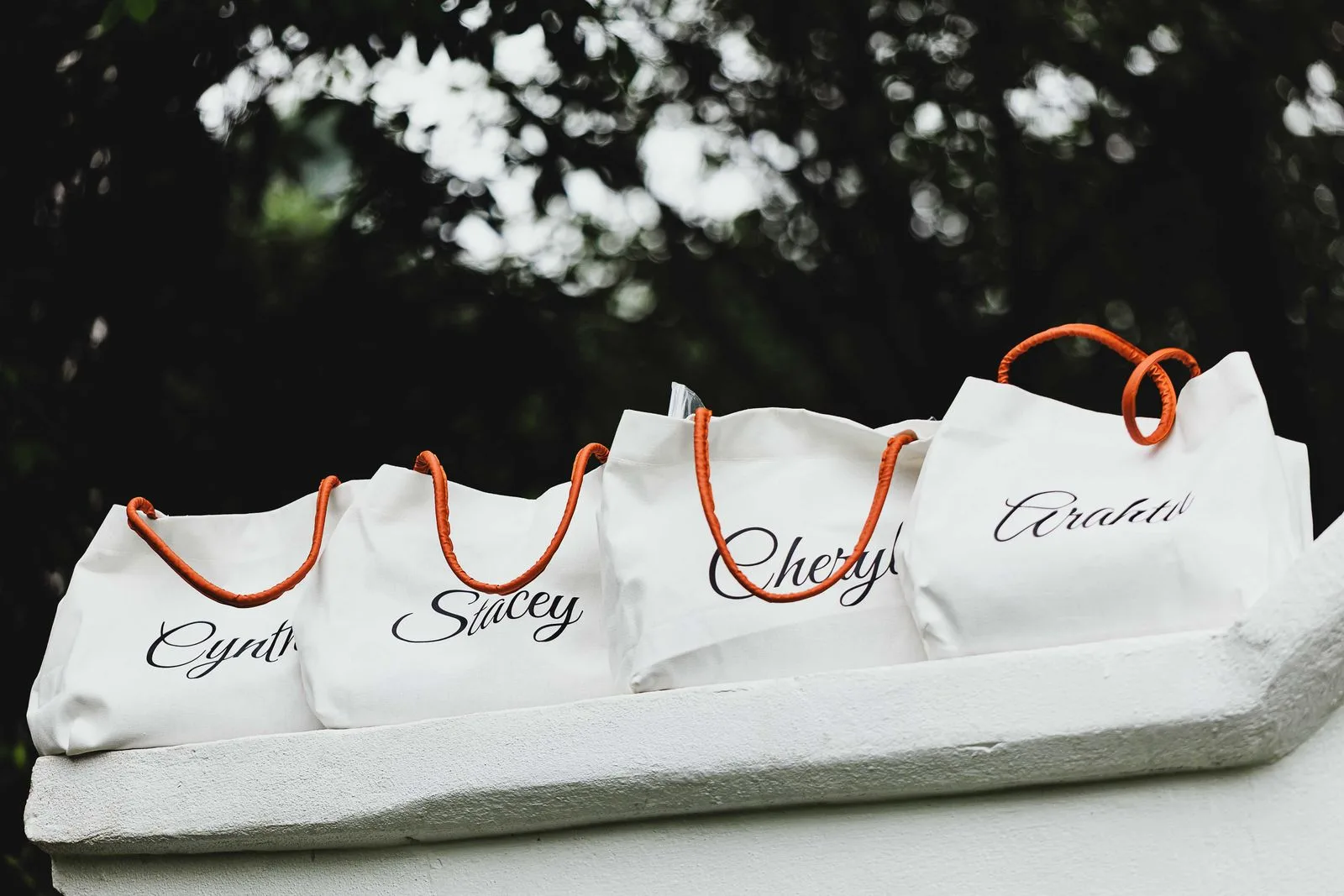 Personalised welcome tote bags lined up for wedding guests | Wedded Wonderland