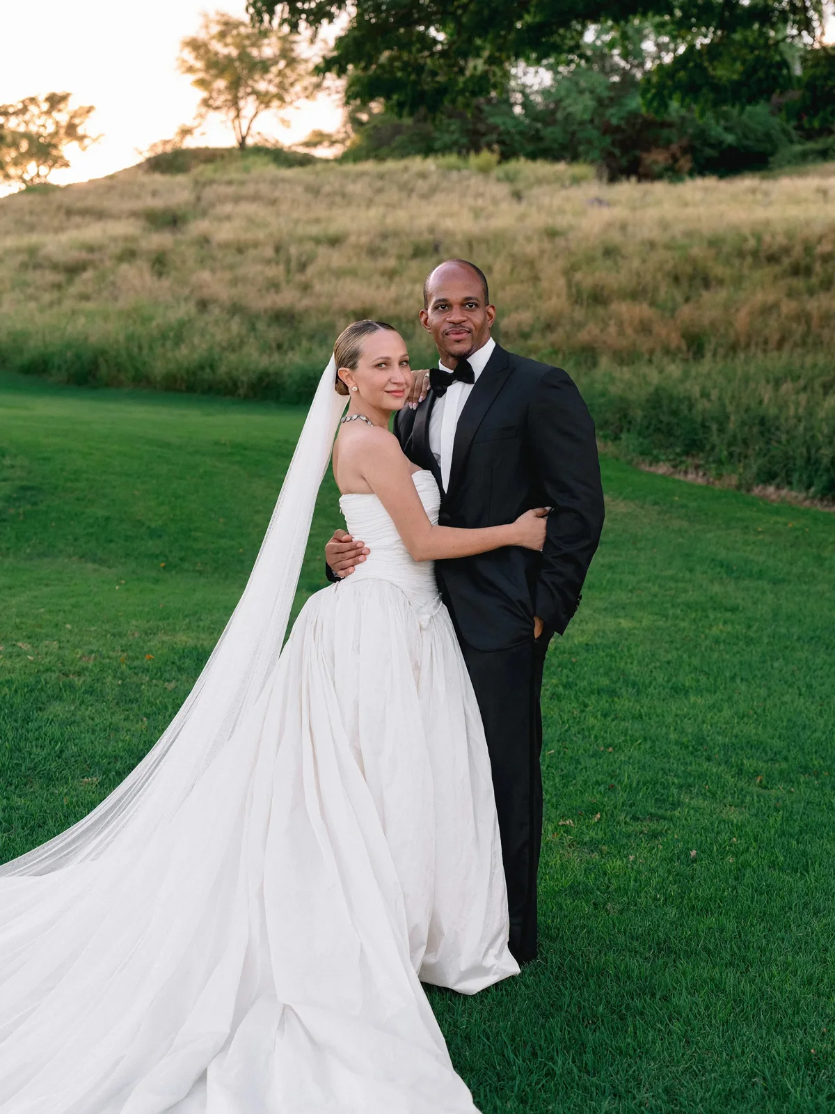 Jennifer Meyer in a strapless Danielle Frankel gown and cathedral veil with Geoffrey Ogunlesi on the lawn at Four Seasons Resort Lanai | Wedded Wonderland