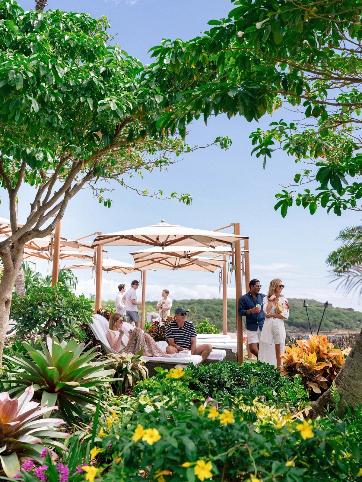 Guests at the pool party under cabanas at Four Seasons Resort Lanai during the Meyer and Ogunlesi wedding weekend | Wedded Wonderland