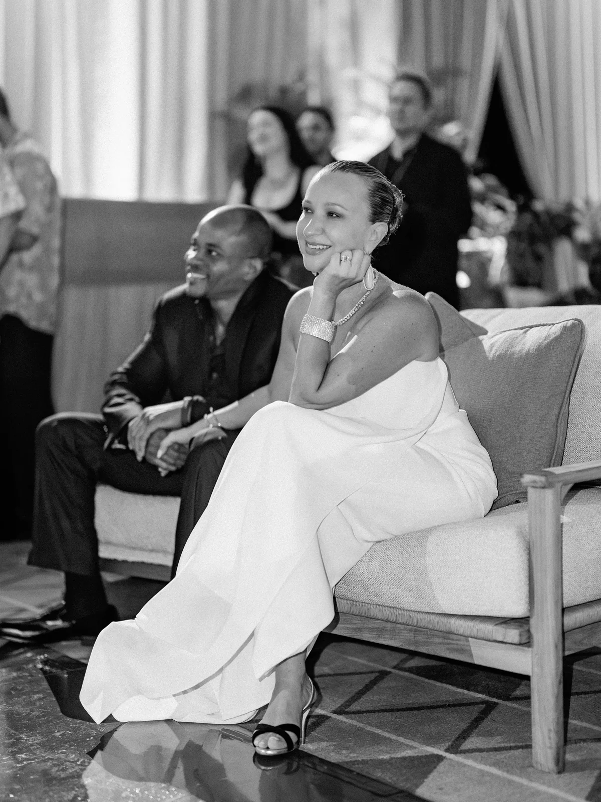 Jennifer Meyer smiling in a white strapless gown in a lounge at her Lanai wedding reception | Wedded Wonderland