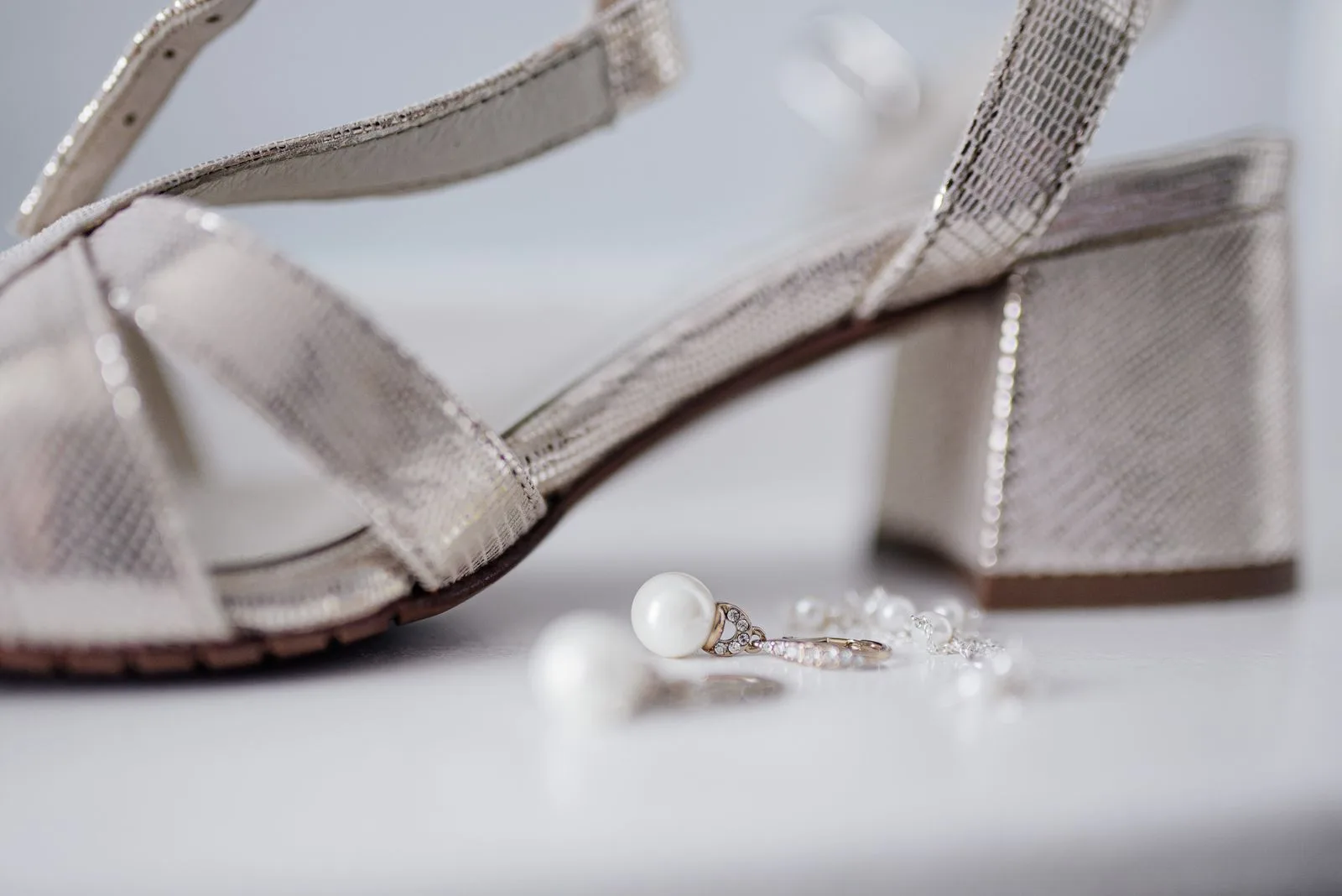 Silver block heel sandals and pearl earrings, made for a black tie wedding on a lawn | Wedded Wonderland