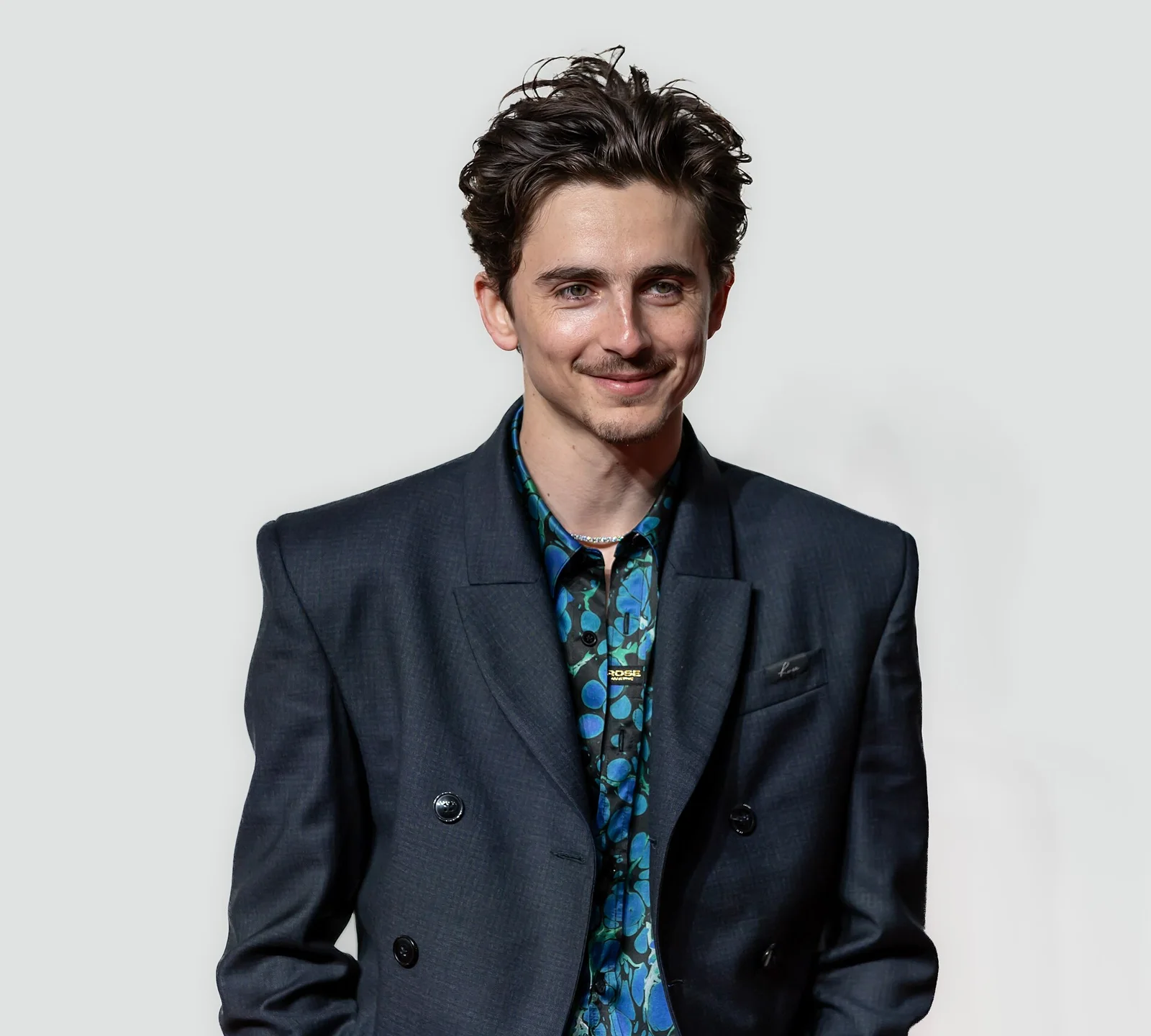 Timothée Chalamet in a dark suit at an event in London in 2025 | Wedded Wonderland